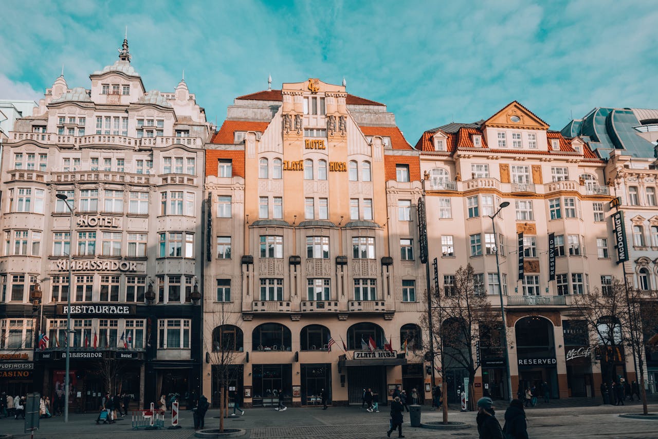 Front view of historical buildings in Wenceslas Square, Prague, showcasing Hotel Zlata Husa.