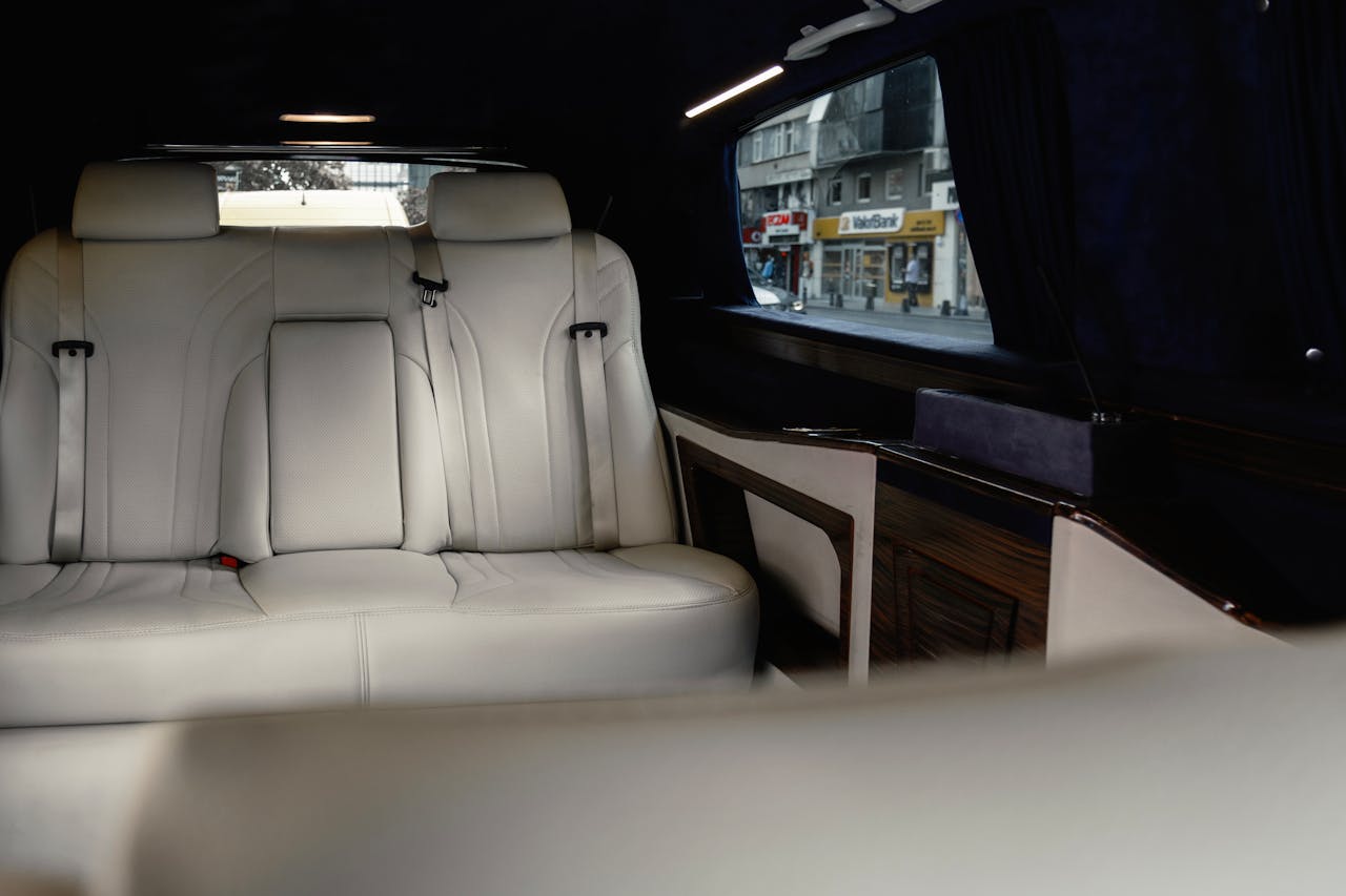 Elegant white leather seats in a Mercedes-Benz V-Class with urban view.
