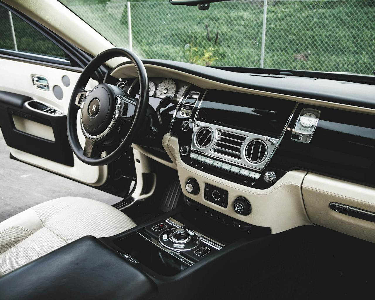 Explore this elegant luxury car interior featuring premium leather and wood accents.